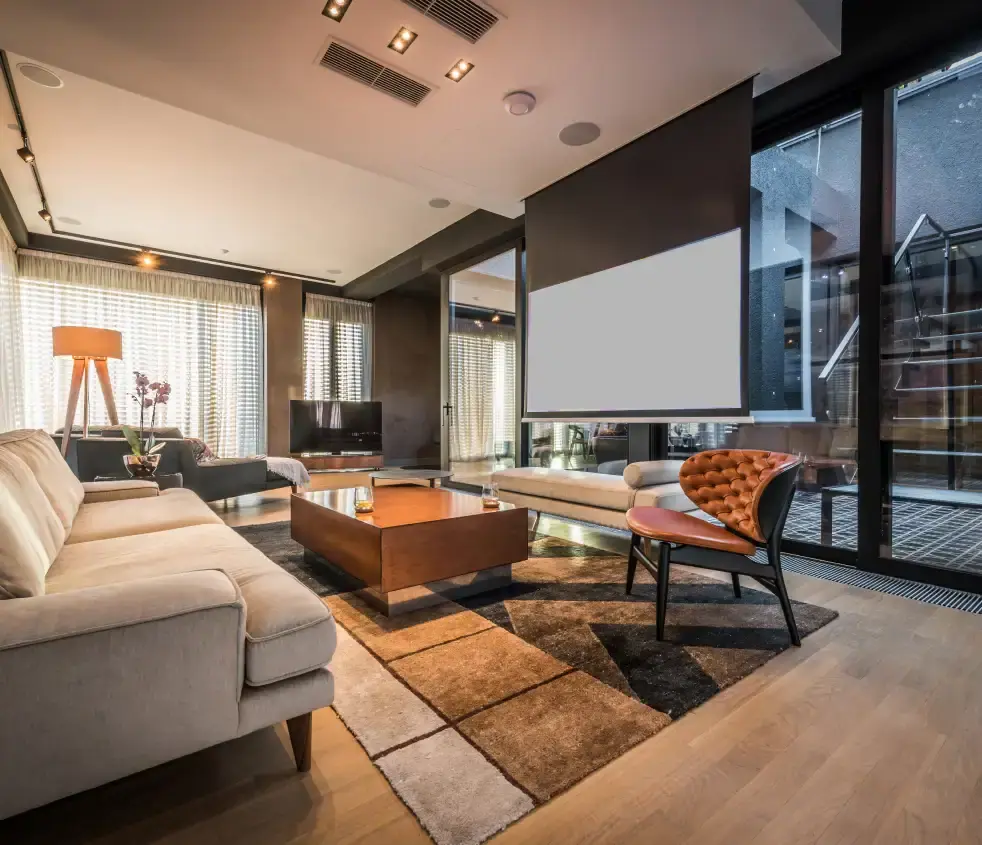 Apartment living room with a projector screen, sofa and leather armchair