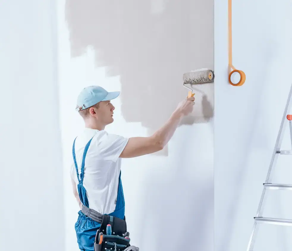 Professional painter evaluating tools and color swatches for painting services in Dubai