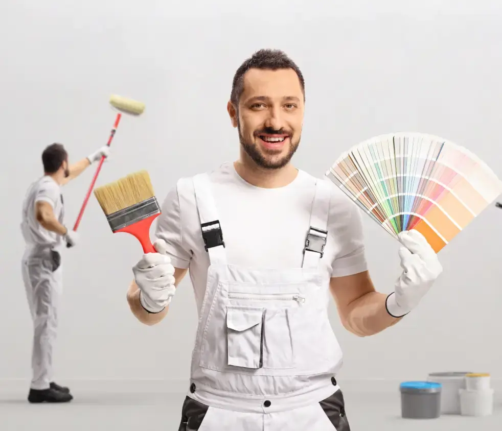 Painter applying color to interior wall showcasing UAE-specific painting techniques